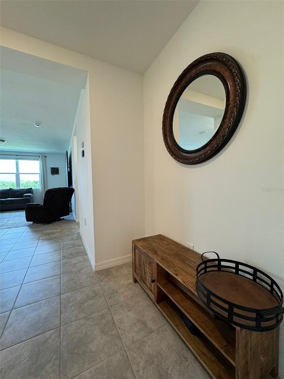 4836 Rigging Street Haines City, FL 33844 - Photo 13 of 29 a living room with a couch and a mirror