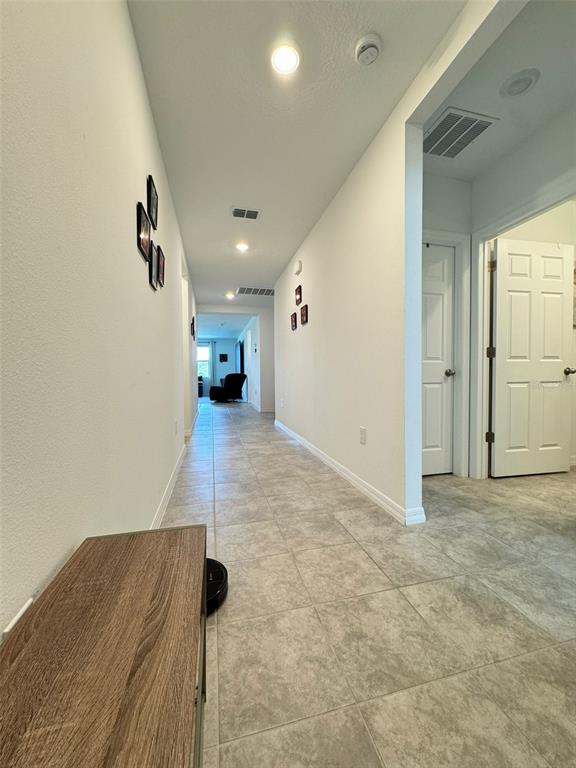 4836 Rigging Street Haines City, FL 33844 - Photo 14 of 29 a view of a big room with wooden floor and a ceiling fan