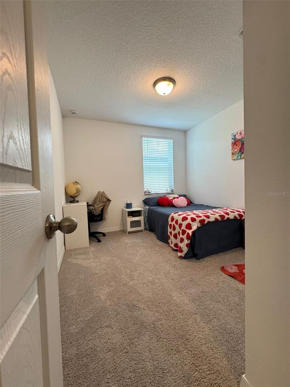 4836 Rigging Street Haines City, FL 33844 - Photo 19 of 29 a bedroom with bed and a window