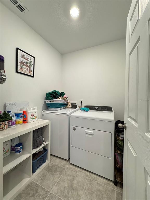4836 Rigging Street Haines City, FL 33844 - Photo 21 of 29 a utility room with dryer and washer