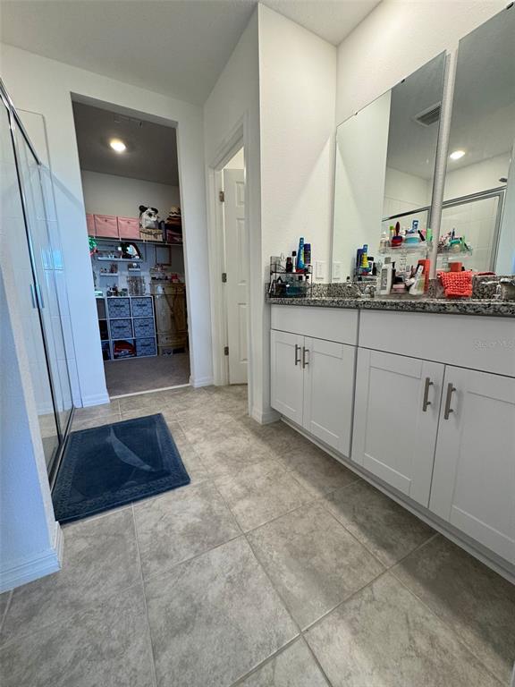 4836 Rigging Street Haines City, FL 33844 - Photo 23 of 29 a spacious bathroom with mirror and sink