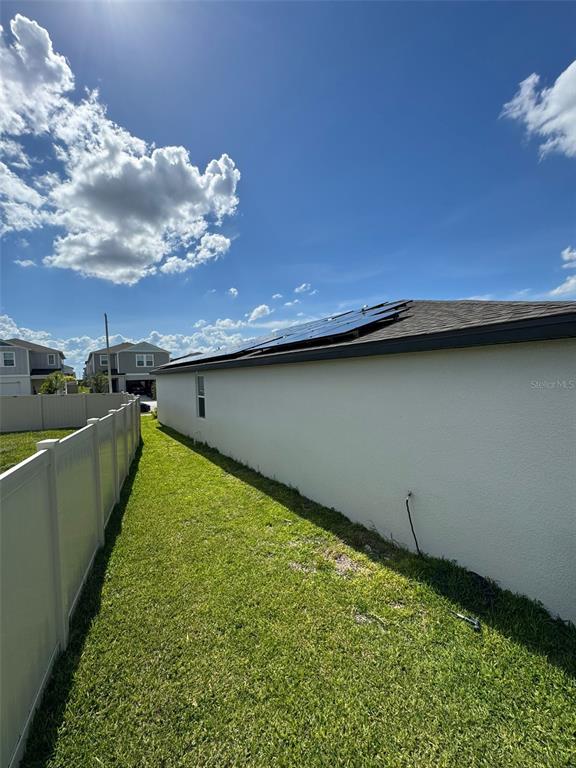 4836 Rigging Street Haines City, FL 33844 - Photo 28 of 29 a view of a backyard with plants and a lake