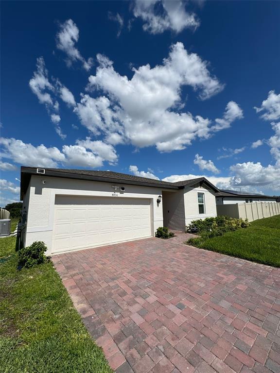 4836 Rigging Street Haines City, FL 33844 - Photo 3 of 29 a front view of a house with a yard and garage