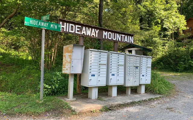 a view of a wooden house with a small yard