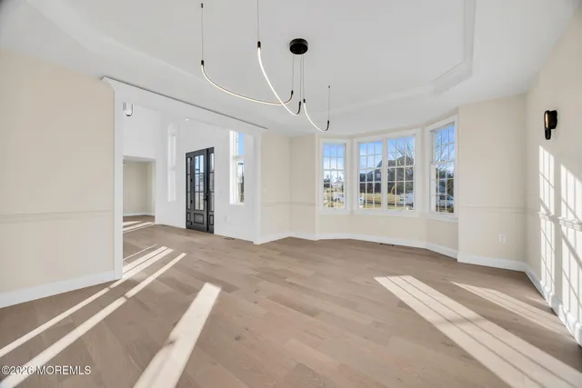 a view of an empty room with a fireplace and a window