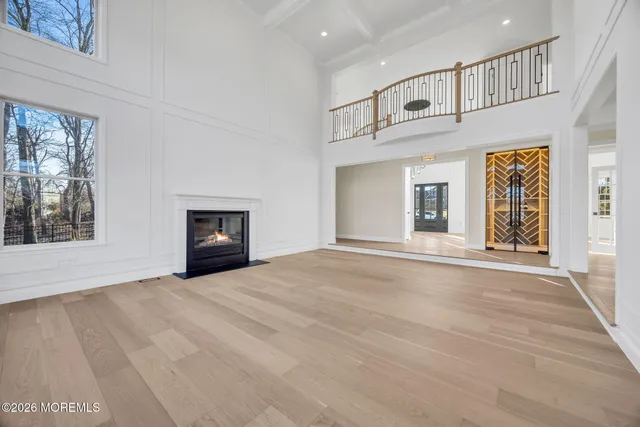 an empty room with windows and fireplace