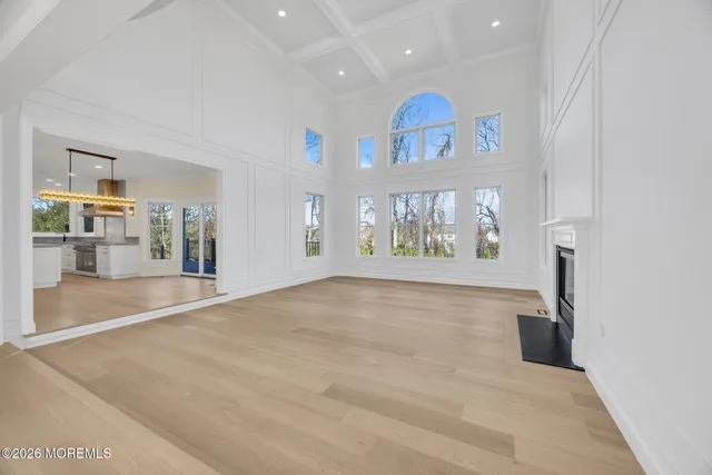 a kitchen with white cabinets and chairs