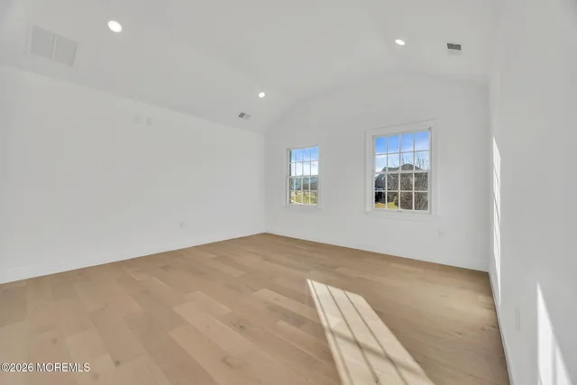 a spacious bathroom with a granite countertop sink a mirror and a shower