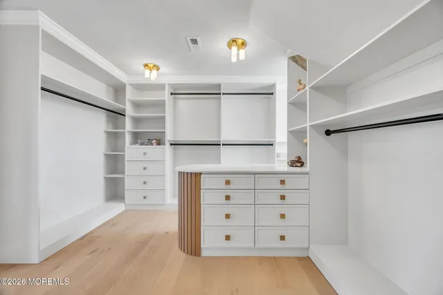 a view of empty room with a kitchen