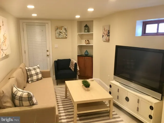 a view of living room with furniture and a flat screen tv