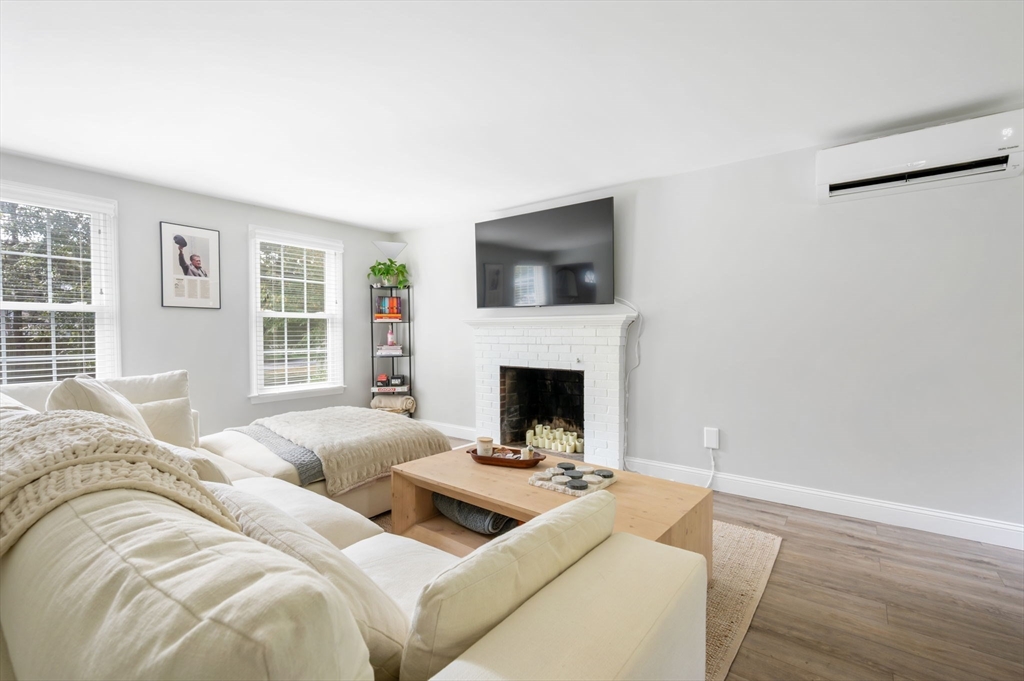99 Doane Street Cohasset, MA 02025 - Photo 12 of 36 a living room with furniture a fireplace and a flat screen tv