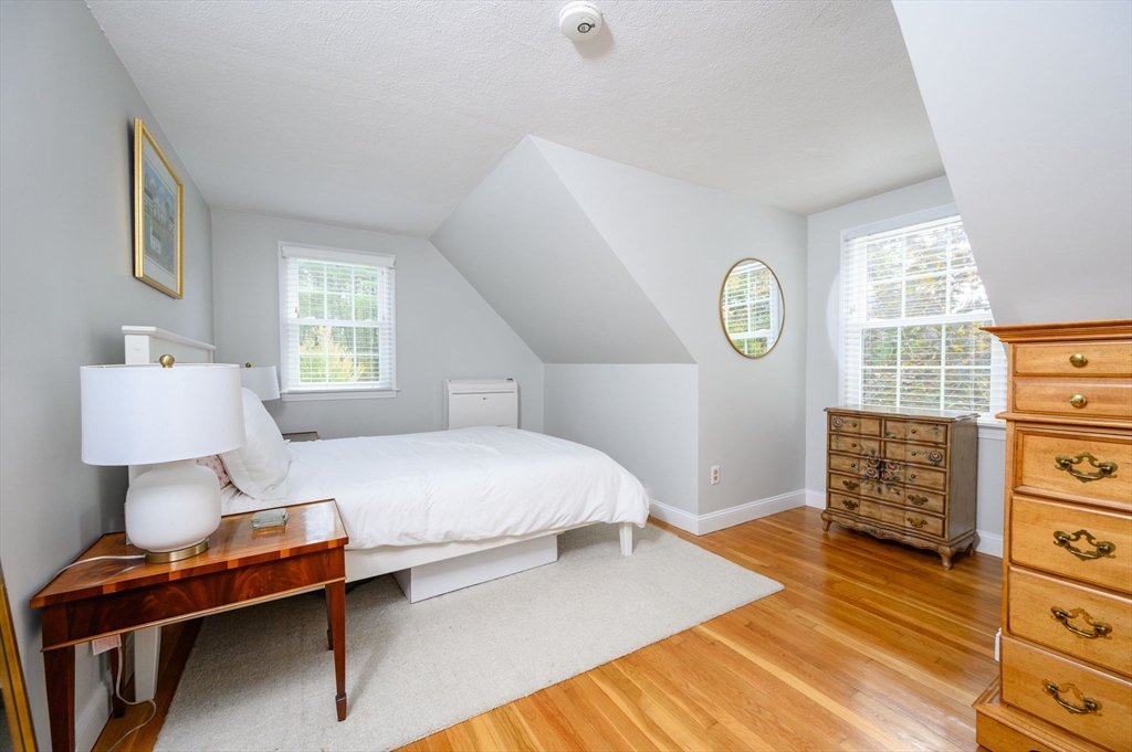 99 Doane Street Cohasset, MA 02025 - Photo 23 of 36 a bedroom with a bed and a dresser