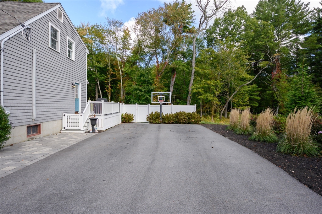 99 Doane Street Cohasset, MA 02025 - Photo 27 of 36 a view of a house with backyard and trees