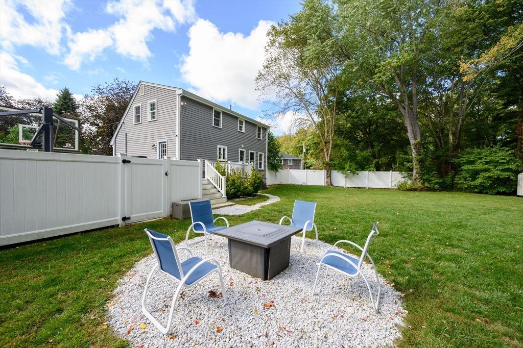 99 Doane Street Cohasset, MA 02025 - Photo 29 of 36 a view of a house with backyard sitting area and garden