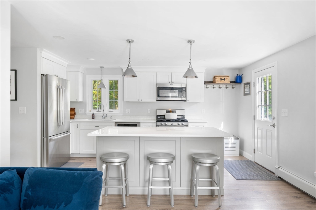 99 Doane Street Cohasset, MA 02025 - Photo 4 of 36 a kitchen with cabinets and wooden floor