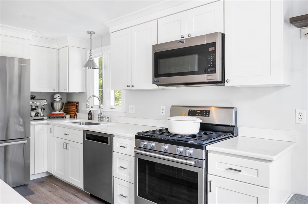 99 Doane Street Cohasset, MA 02025 - Photo 5 of 36 a kitchen with stainless steel appliances a stove microwave and sink