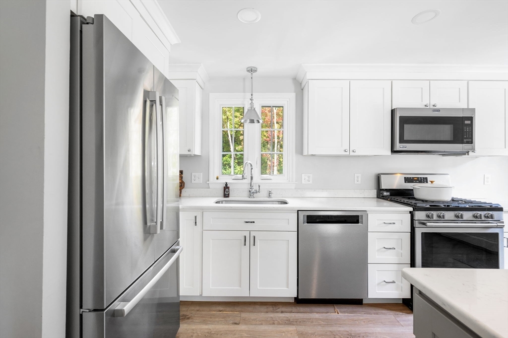 99 Doane Street Cohasset, MA 02025 - Photo 8 of 36 a kitchen with stainless steel appliances granite countertop a stove a sink and a microwave