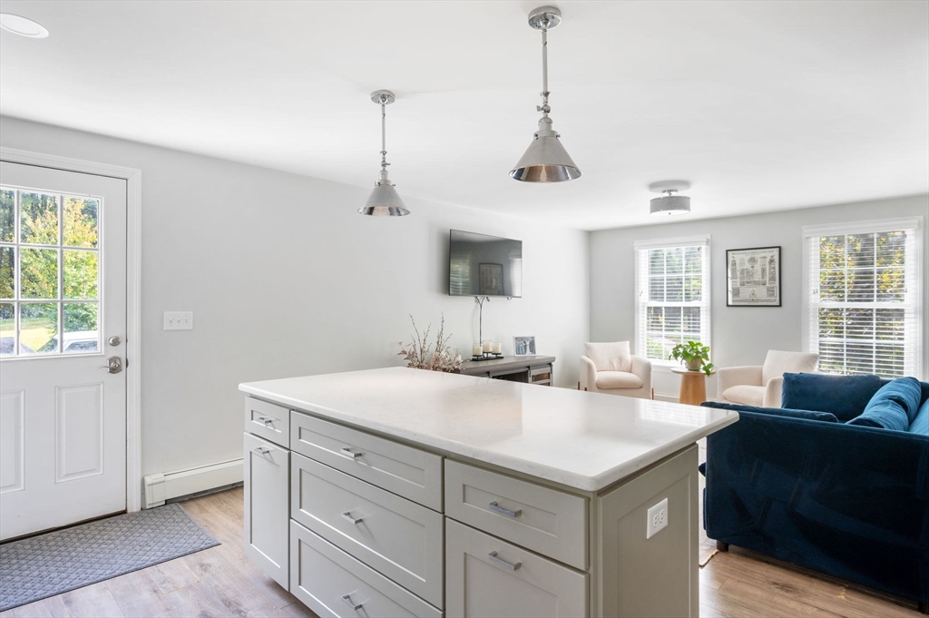 99 Doane Street Cohasset, MA 02025 - Photo 9 of 36 a view of living room with granite countertop furniture and fireplace