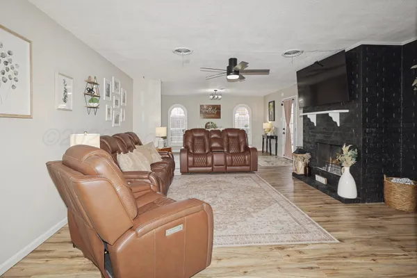 a living room with furniture and a fireplace