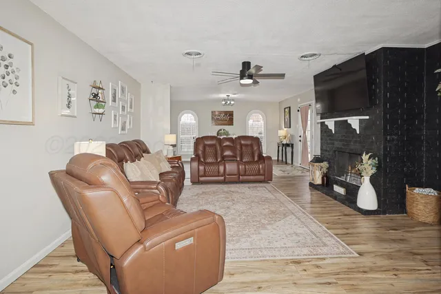 a living room with furniture and a fireplace