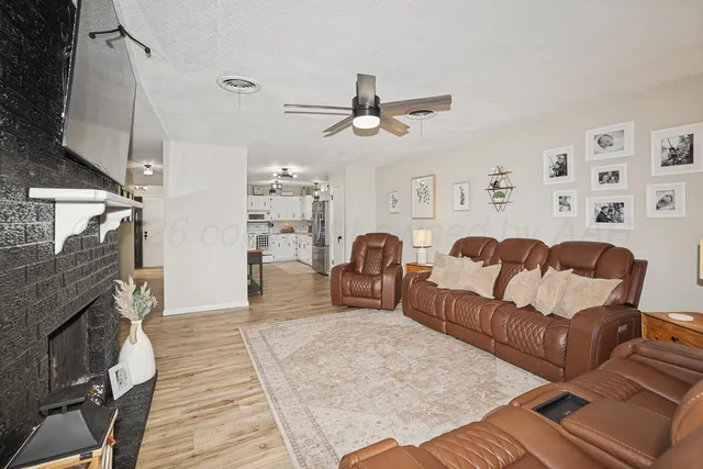 a living room with furniture and a fireplace