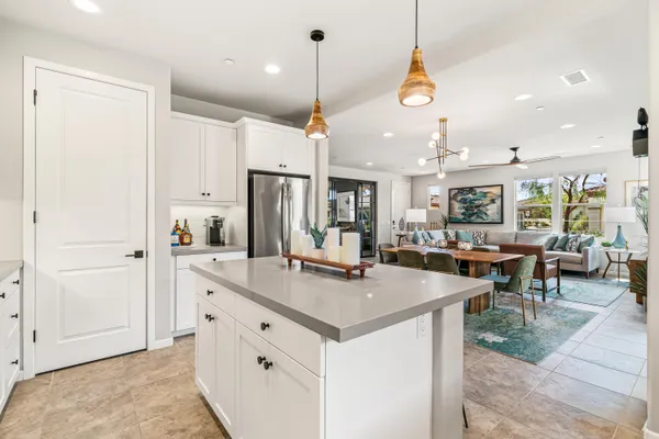 a kitchen with stainless steel appliances granite countertop a sink a stove and a refrigerator