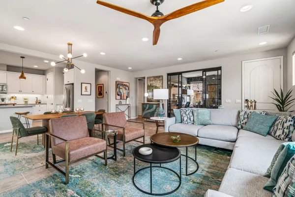 a living room with furniture and a chandelier