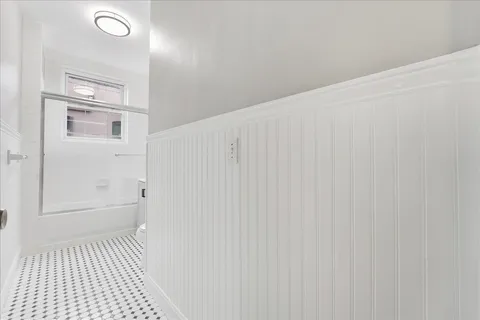 a bedroom with double bed and a window