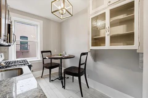 a view of a dining room with furniture and a window