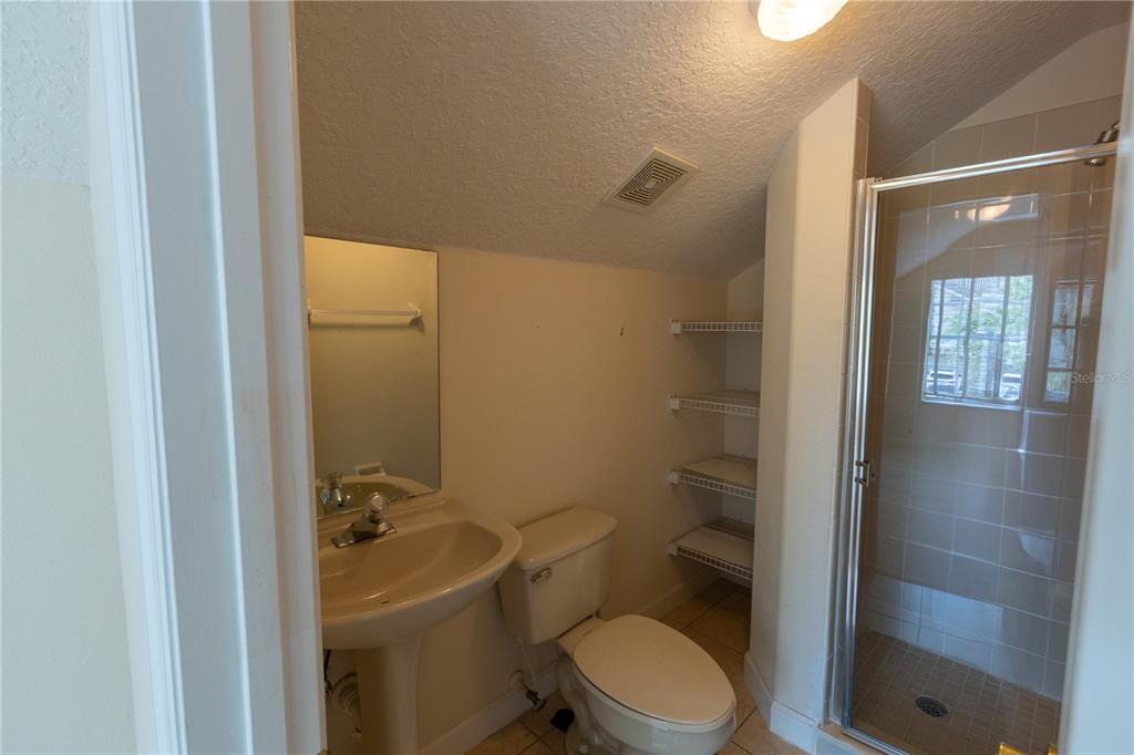 65 Calliope Street Ocoee, FL 34761 - Photo 38 of 60 a bathroom with a granite countertop toilet and a shower