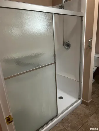 a bathroom with a glass shower door