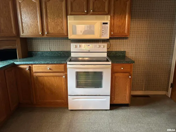 a stove top oven sitting inside of a kitchen