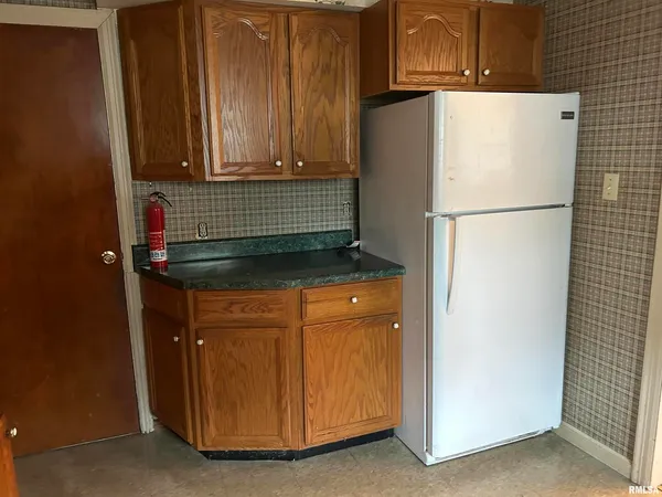 a white refrigerator freezer sitting in a kitchen