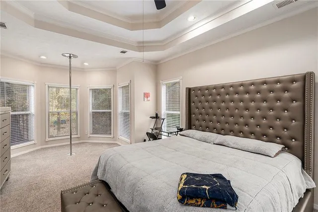 a bedroom with a large bed and a large window