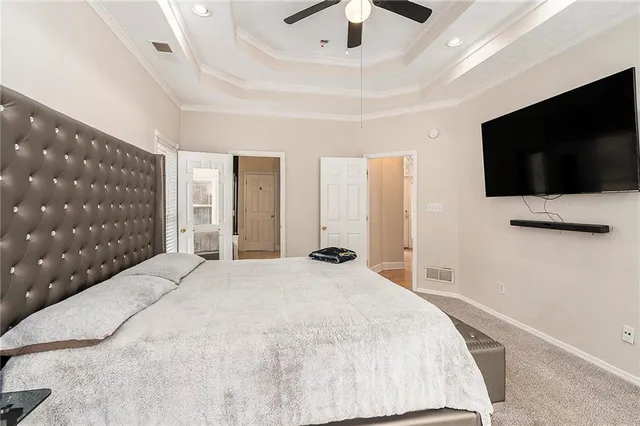a bedroom with a large bed and a flat screen tv