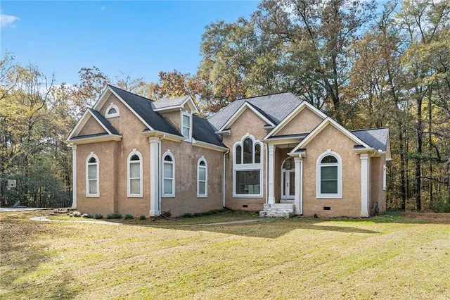 a front view of a house with a yard