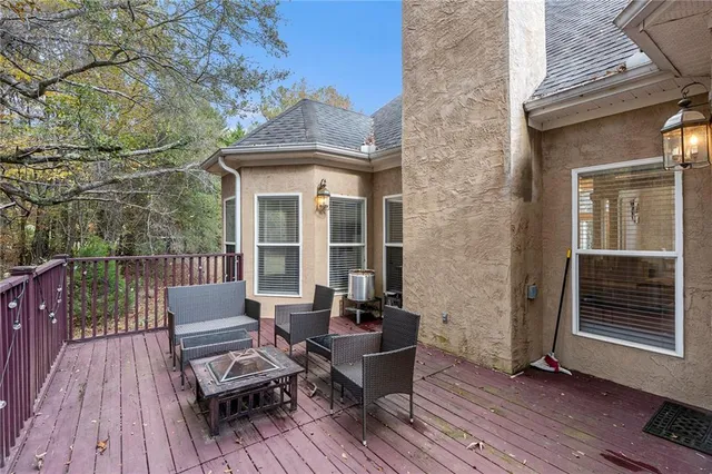 a view of a deck with chairs and wooden floor
