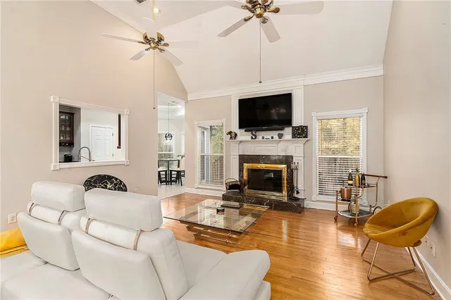 a living room with furniture a fireplace and a flat screen tv