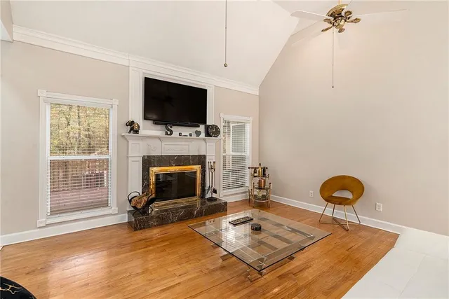 a living room with furniture a flat screen tv and a fireplace