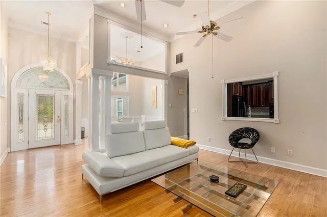 a living room with furniture and a chandelier