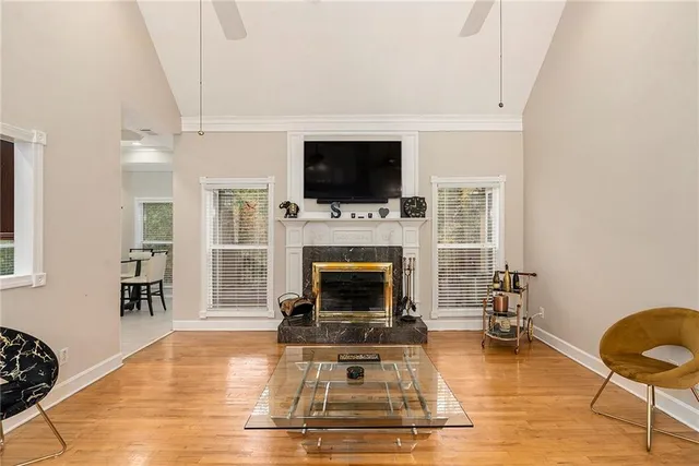 a living room with furniture a flat screen tv and a fireplace