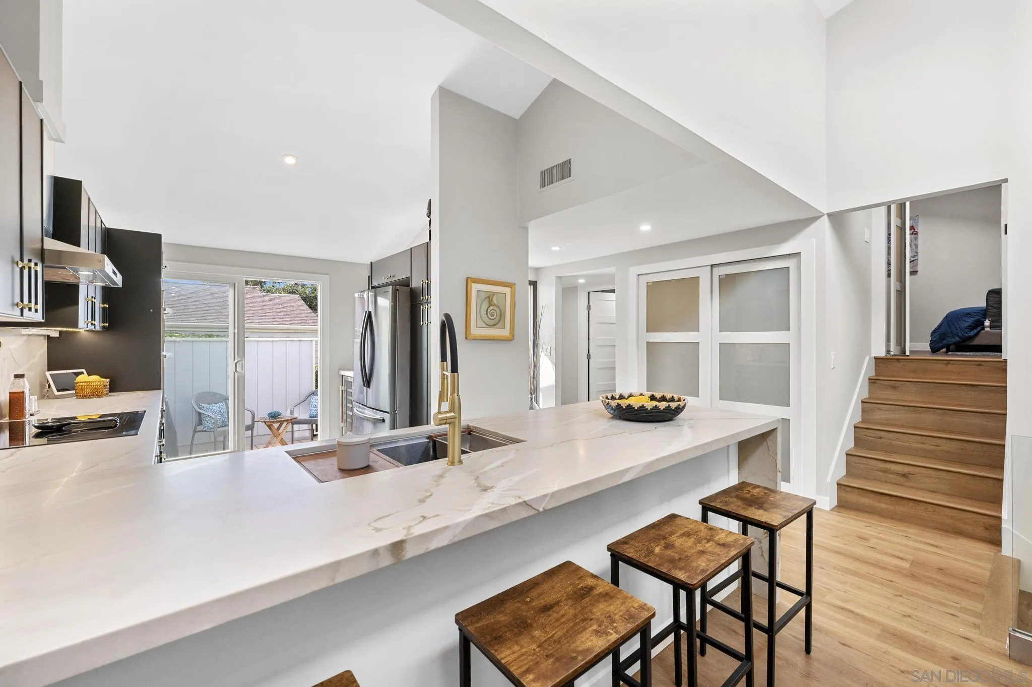 1735 Aldersgate Road Encinitas, CA 92024 - Photo 24 of 49 a kitchen with a sink and chairs