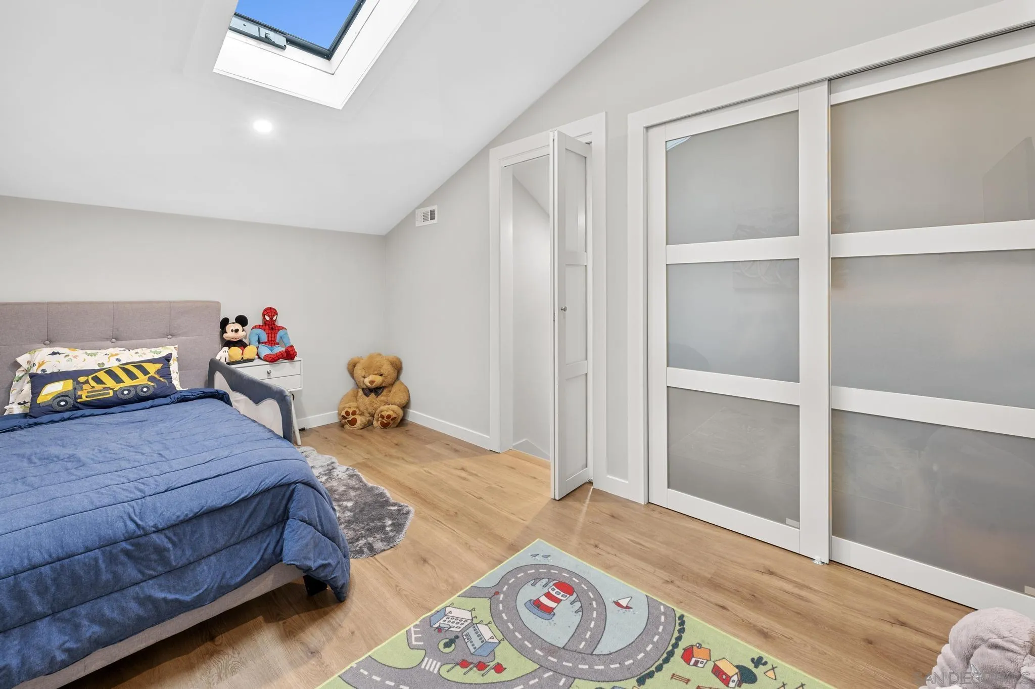 1735 Aldersgate Road Encinitas, CA 92024 - Photo 33 of 49 a bedroom with a bed and wooden floor