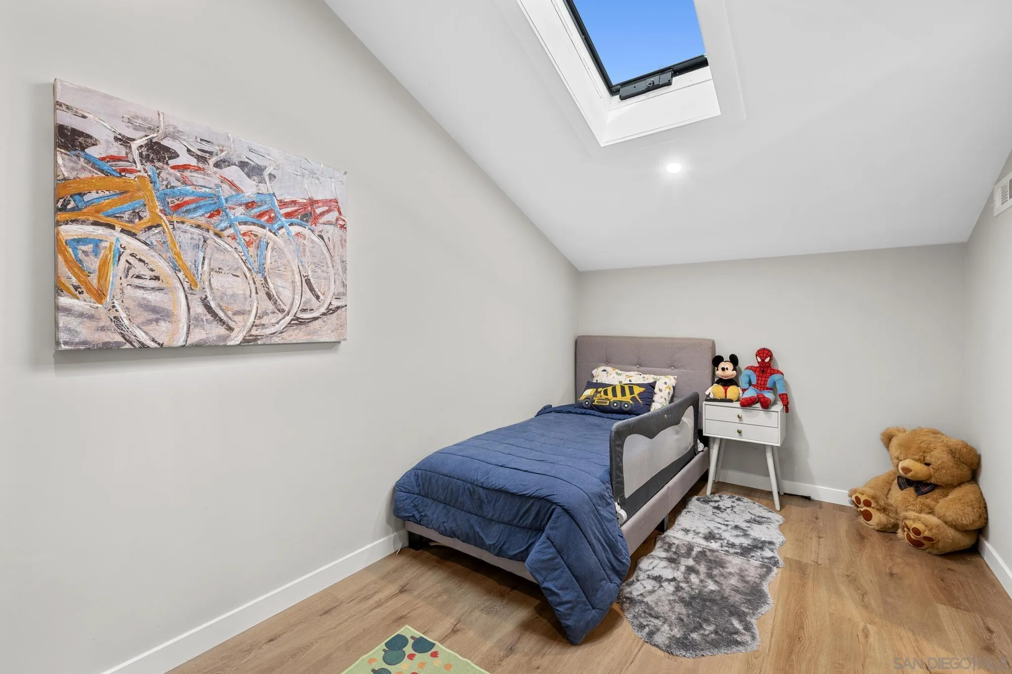 1735 Aldersgate Road Encinitas, CA 92024 - Photo 34 of 49 a bedroom with a bed and wooden floor