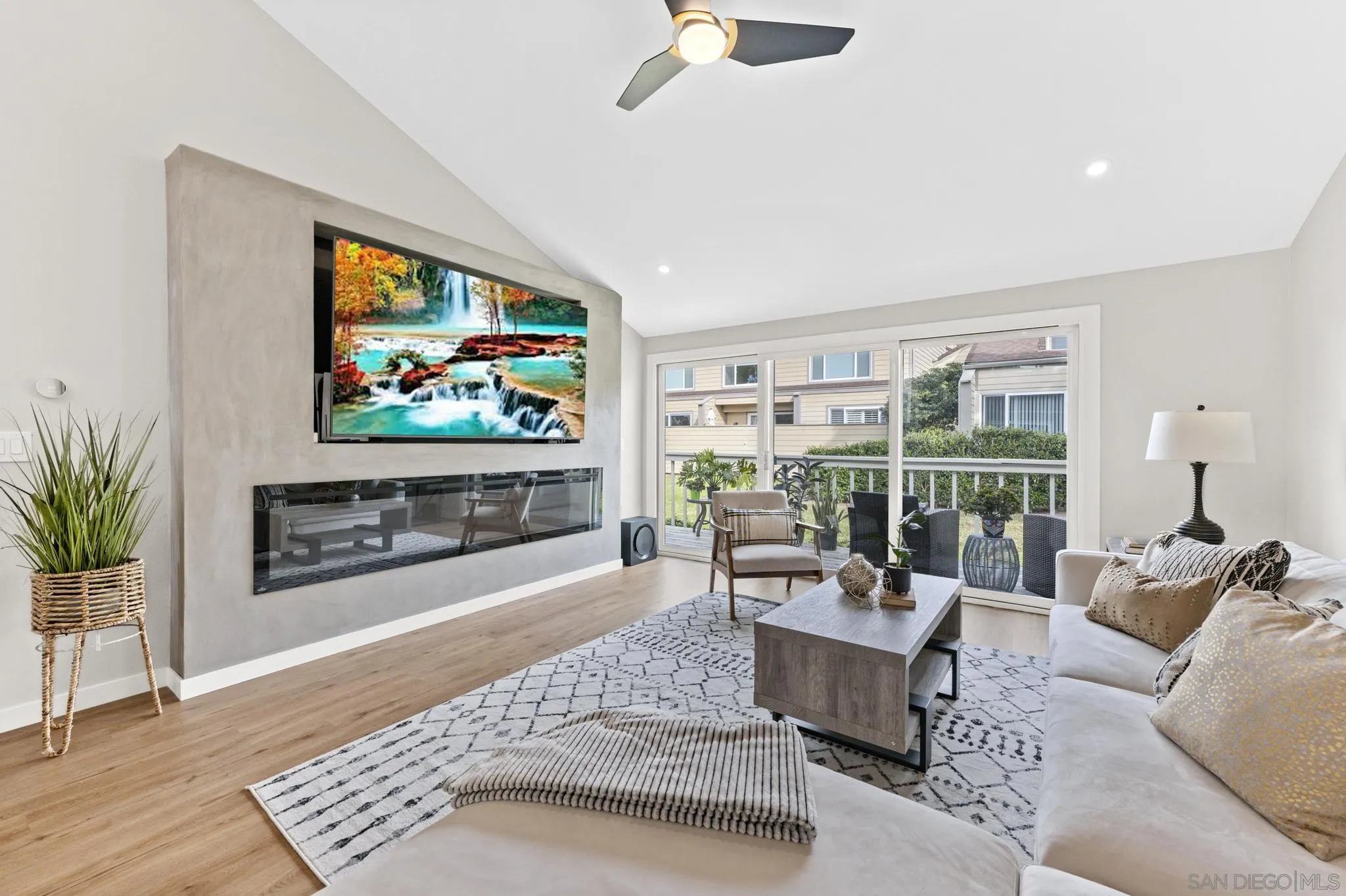 1735 Aldersgate Road Encinitas, CA 92024 - Photo 9 of 49 a living room with furniture a flat screen tv and a fireplace