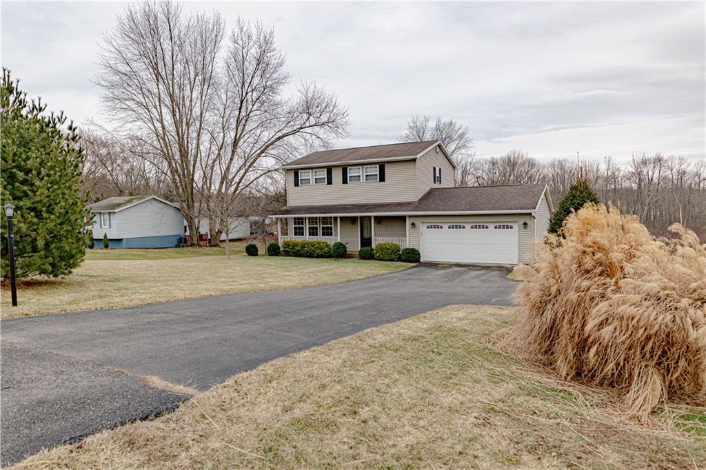 3673 Mitchell Road New Castle, PA 16105 - Photo 2 of 25 a front view of a house with a yard and garage