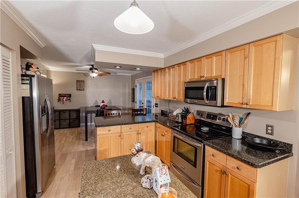 3673 Mitchell Road New Castle, PA 16105 - Photo 7 of 25 a kitchen with granite countertop a sink a counter top space appliances and cabinets