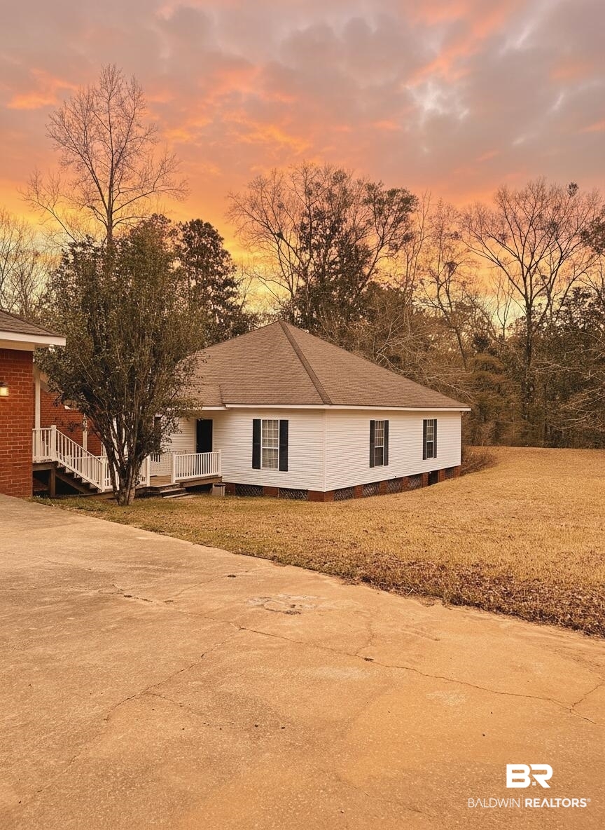 8008 Patricks Landing Road Bay Minette, AL 36507 - Photo 2 of 33 White siding exterior with a brown shingle roof