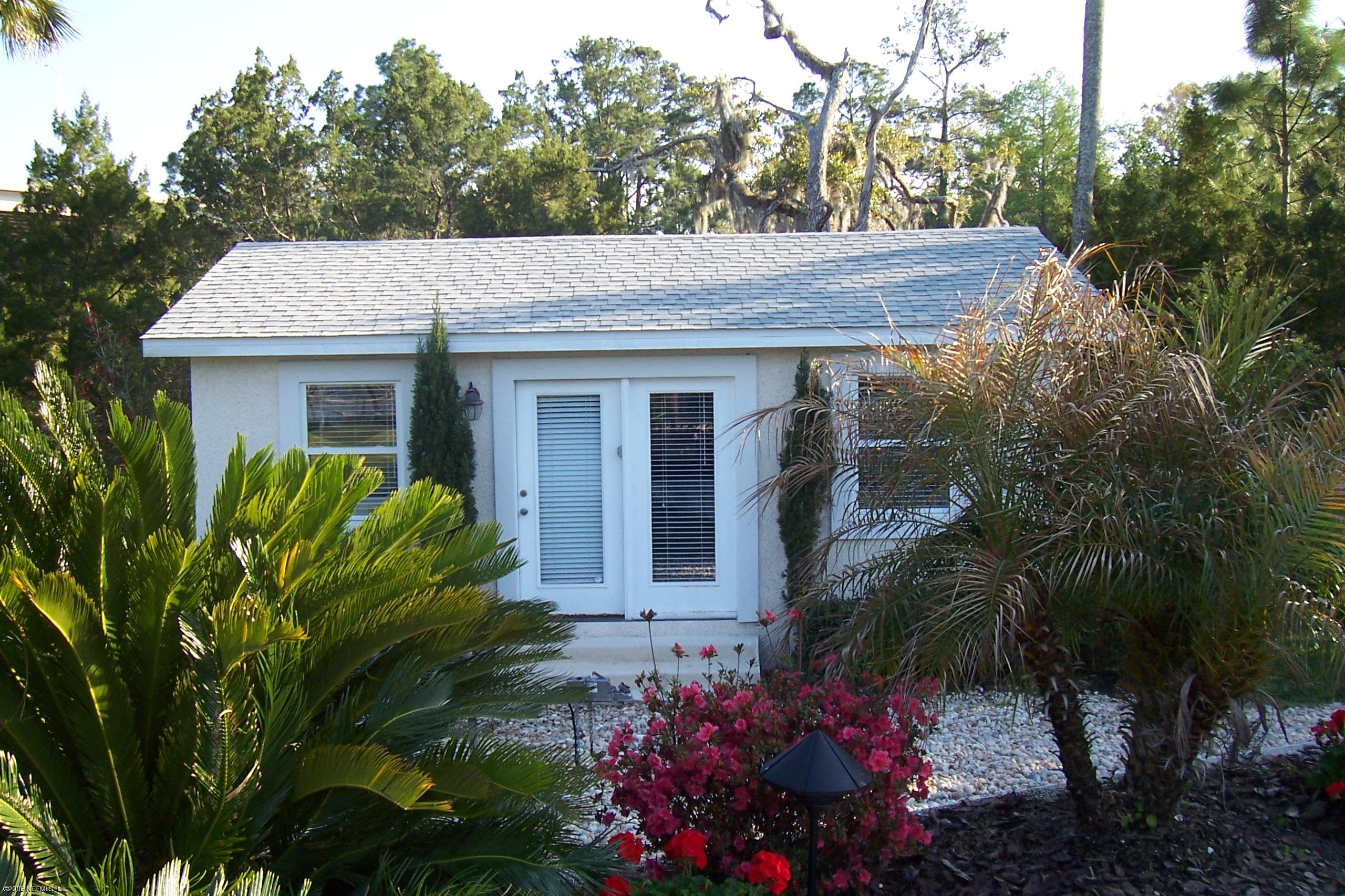 200 Clatter Bridge Road Ponte Vedra Beach, FL 32081 - Photo 11 of 12 a view of a house with a flower garden