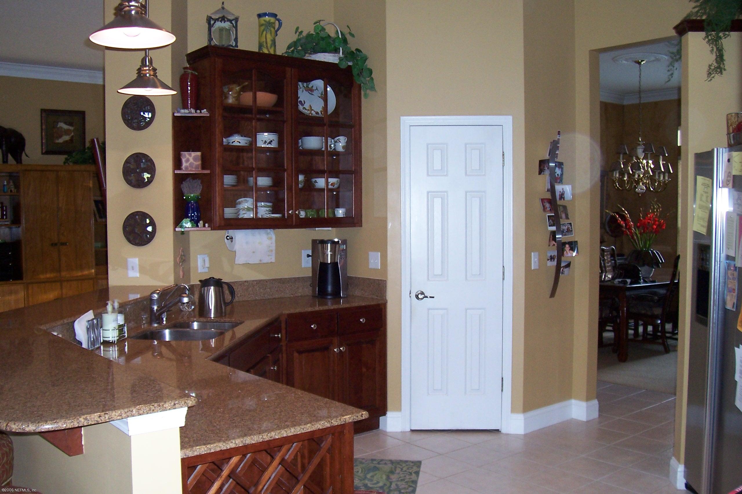 200 Clatter Bridge Road Ponte Vedra Beach, FL 32081 - Photo 5 of 12 a kitchen with a refrigerator and a stove